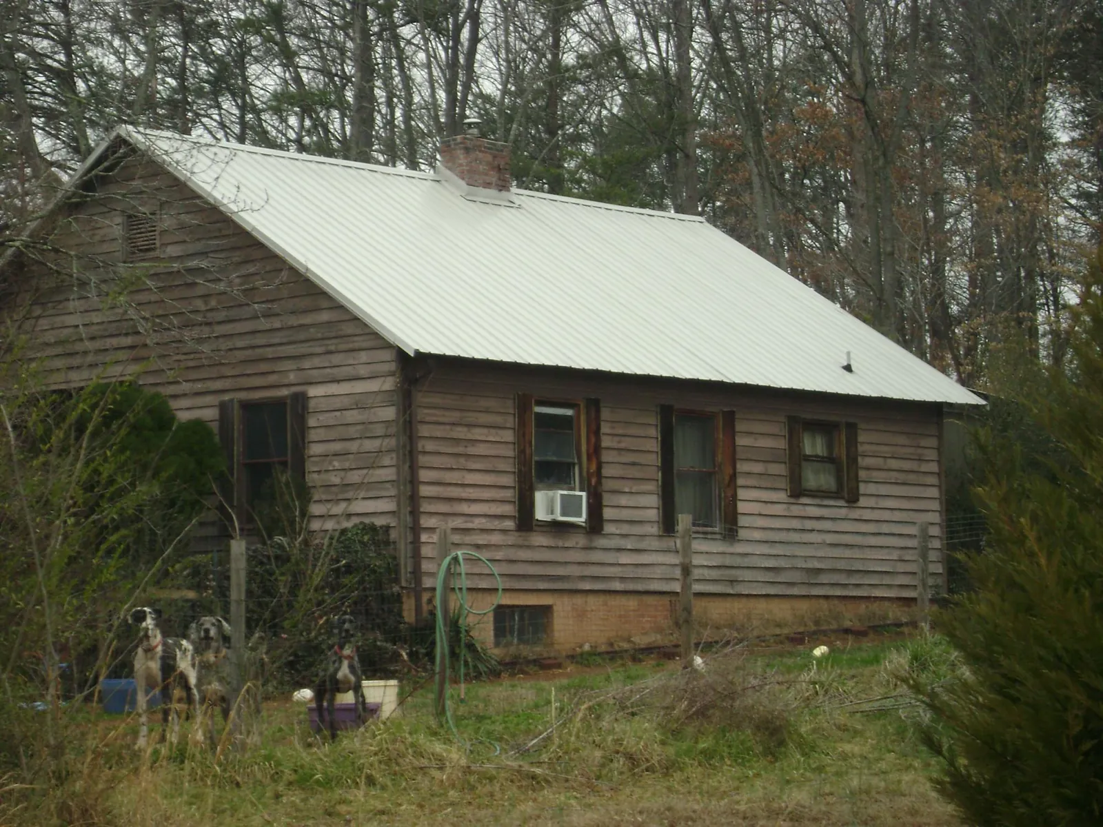 White metal roof on an old wood sided farmhouse, from a Metal Roof Installation job in Bucyrus